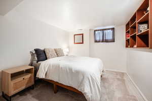 Bedroom featuring light carpet, visible vents, and baseboards