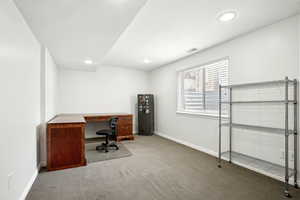 Unfurnished office with carpet floors, baseboards, visible vents, and recessed lighting