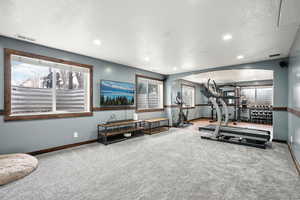 Workout room featuring recessed lighting, visible vents, light carpet, and baseboards