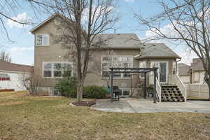 Rear view of property featuring a patio, a shingled roof, a yard, stucco siding, and a pergola