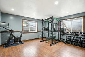 Workout area featuring recessed lighting, a textured ceiling, baseboards, and wood finished floors