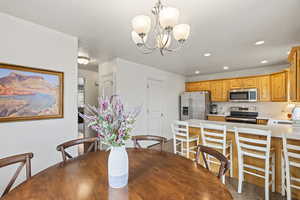 Dining room with a chandelier and recessed lighting