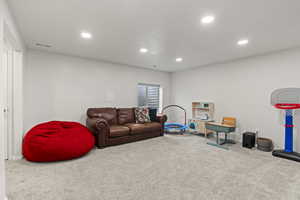 Game room with carpet, visible vents, and recessed lighting