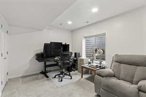 Office area with light carpet, baseboards, visible vents, and recessed lighting