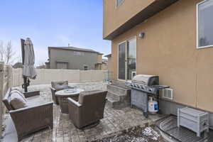 View of patio featuring area for grilling and a fenced backyard