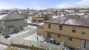 Exterior space featuring entry steps, a fenced backyard, a residential view, cooling unit, and stucco siding