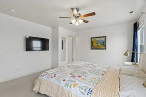 Bedroom featuring carpet floors, visible vents, baseboards, and a ceiling fan