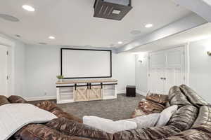 Home theater room featuring carpet floors, visible vents, baseboards, and recessed lighting