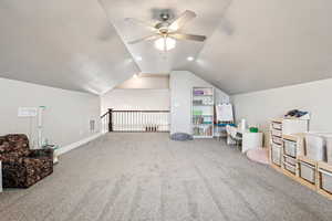 Additional living space featuring baseboards, visible vents, ceiling fan, vaulted ceiling, and carpet floors