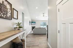 Hallway featuring baseboards, recessed lighting, and light wood-style flooring