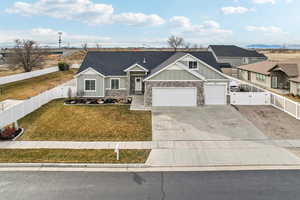 View of front facade featuring a front yard and a garage