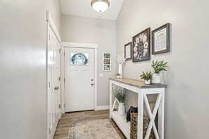 Entryway with light wood-style flooring and baseboards