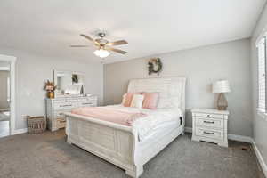 Bedroom featuring carpet, visible vents, baseboards, and ceiling fan