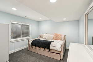 Bedroom featuring baseboards, dark carpet, and recessed lighting