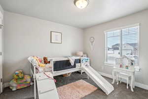 Bedroom with carpet flooring and baseboards