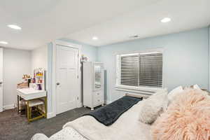 Bedroom featuring visible vents, baseboards, dark colored carpet, and recessed lighting