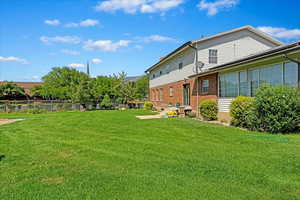 View of yard featuring fence