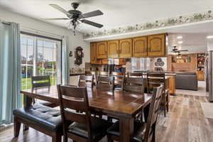 Dining area featuring ceiling fan and light wood-style flooring