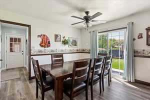 Dining space featuring ceiling fan, wood finished floors, and baseboards