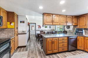 Kitchen featuring a peninsula and brown cabinets