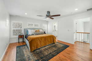 Bedroom featuring light wood finished floors, visible vents, and recessed lighting