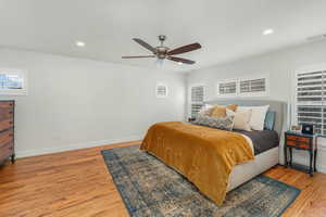 Bedroom featuring baseboards, visible vents, a ceiling fan, wood finished floors, and recessed lighting