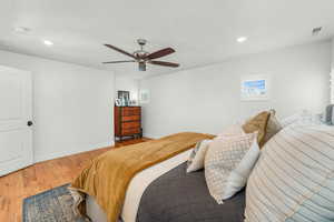 Bedroom with recessed lighting, visible vents, a ceiling fan, wood finished floors, and baseboards