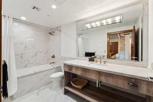 Full bath with shower / bathtub combination, toilet, marble look tile flooring, vanity, and recessed lighting