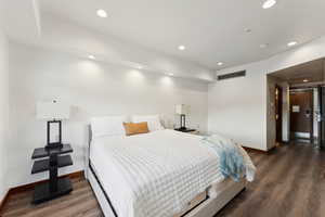Bedroom featuring baseboards, wood finished floors, and recessed lighting