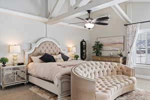 Carpeted bedroom with a high ceiling, a ceiling fan, and baseboards