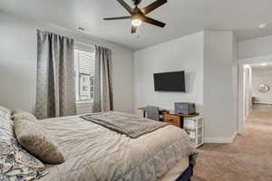 Bedroom featuring baseboards, ceiling fan, visible vents, and light colored carpet