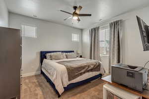 Carpeted bedroom featuring visible vents, ceiling fan, and baseboards