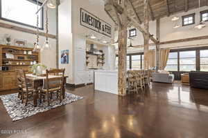 Dining area with finished concrete flooring, wooden ceiling, a healthy amount of sunlight, and beam ceiling