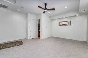 Interior space featuring light carpet and ceiling fan