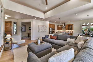 Living room featuring a notable chandelier and light hardwood / wood-style flooring