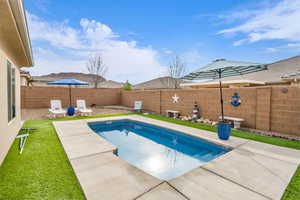 View of pool featuring a fenced in pool, a fenced backyard, and a yard