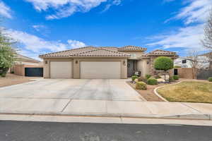 Mediterranean / spanish-style home with driveway, an attached garage, a tiled roof, and stucco siding