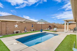 View of swimming pool with a fenced in pool, a fenced backyard, and a patio