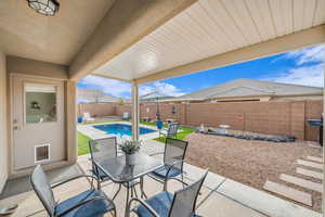 View of patio featuring a mountain view, a fenced backyard, and a fenced in pool