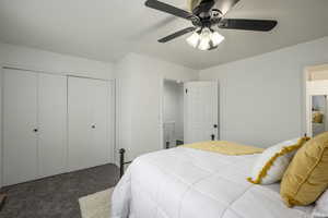 Bedroom featuring a ceiling fan, dark colored carpet, and a closet