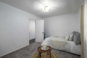 Bedroom featuring carpet floors and baseboards