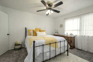 Bedroom featuring a ceiling fan, carpet flooring, and visible vents