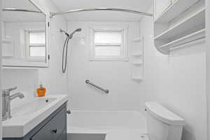 Full bath with vanity, toilet, and plenty of natural light