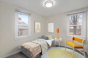 Carpeted bedroom featuring baseboards