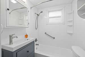 Full bath featuring vanity, shower / bath combination, and toilet