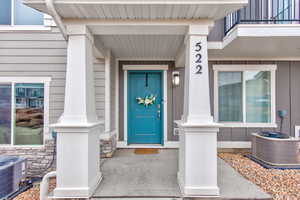 Property entrance with fiber cement siding and stone wainscoting