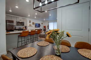 Dining space featuring light wood-style flooring and recessed lighting