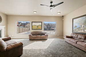 Living room featuring ceiling fan and carpet floors