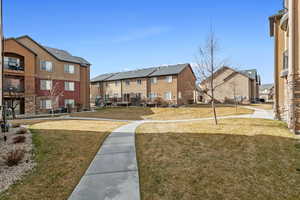 View of home's community with a lawn