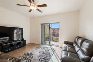 Living room featuring ceiling fan and light hardwood / wood-style flooring